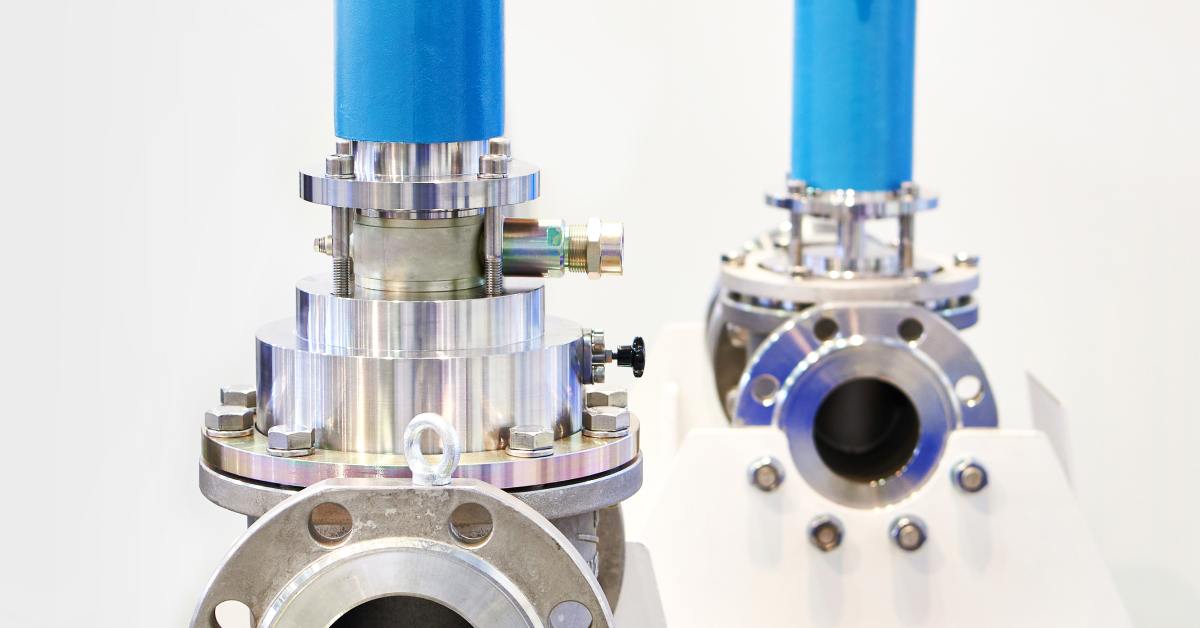 Two industrial electromagnetic valves with blue upper sections and metallic bases, displayed on a white background.