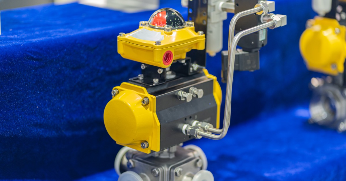 Automatic valves and metal pipe fittings connected to cables and gauges inside an industrial equipment area.
