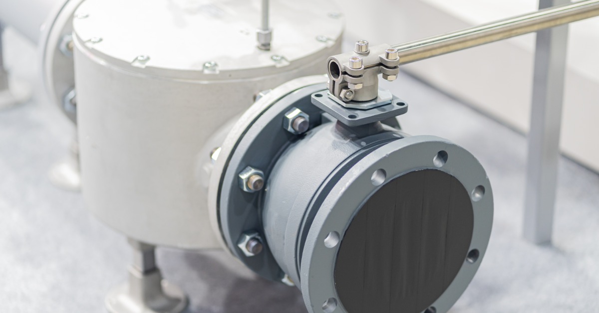 Automatic valves and metal pipe fittings connected to cables and gauges inside an industrial equipment area.